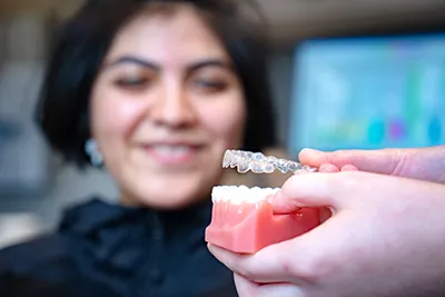 A dental specialist explaining a teeth x-ray to a patient.