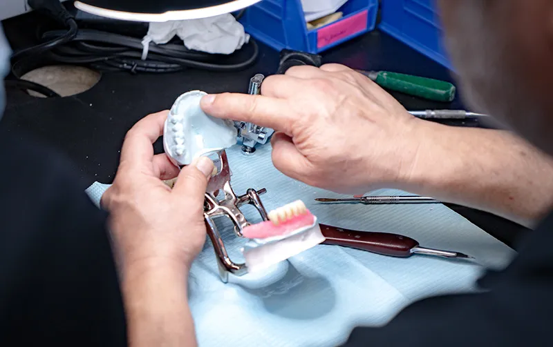 A dentist smiling at the dental chair.